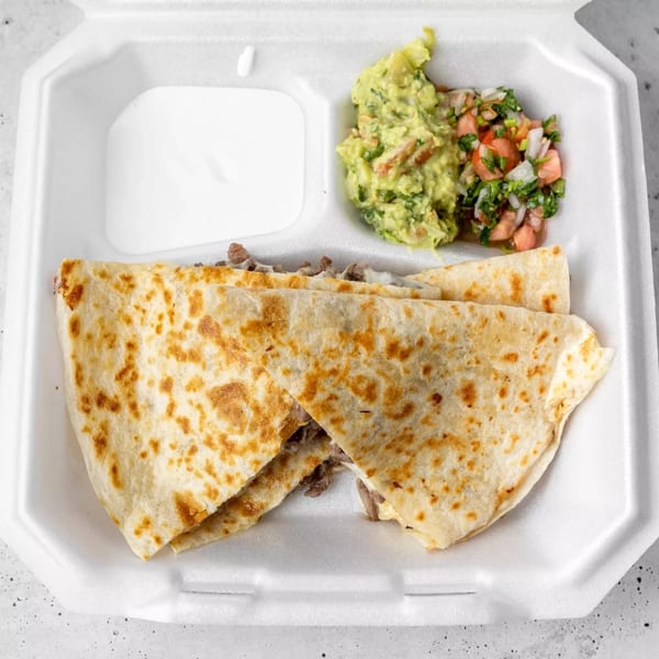 Two quesadillas with meat and cheese, served with guacamole, pico de gallo, and sour cream.
